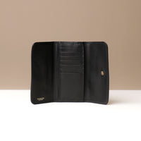Black leather wallet open against a neutral background