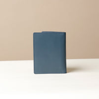 Blue Back view of leather passport case Nirua on neutral background