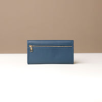 Blue wallet with gold zipper on a neutral background
