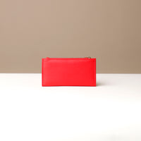 Red leather wallet on a neutral background