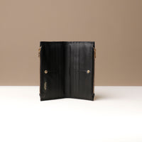 Black leather wallet open on a neutral background