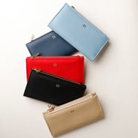 Five colorful pouches stacked on a light background.