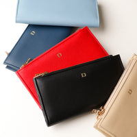 Assortment of Russet Wallets in black, blue, red, and beige colors, displayed flat on a white surface.