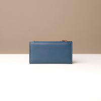 Blue leather pouch on a neutral background