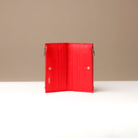 Red leather wallet on a neutral background