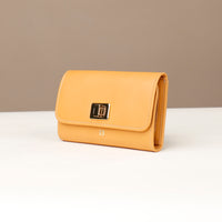 Yellow wallet with a brand logo on a beige background