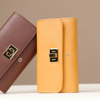Two leather wallets, one brown and one yellow, on a neutral background