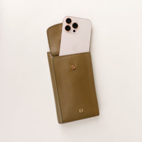 front view of a open green danilos leather multi smartphone alessia with a phone inside a pocket over a white background
