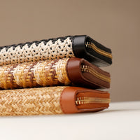 Stack of woven bags with zippers on a neutral background