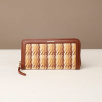 Woven wallet with brown and beige pattern on a white surface with a beige background