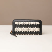 Black and white striped wallet with 'Danilos' branding on a beige background