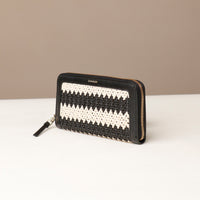 Woven wallet with black and white pattern on a beige background