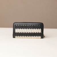 Black and white striped wallet on a beige background
