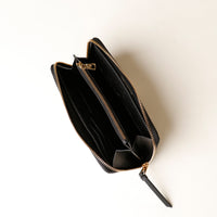 Black wallet with gold zipper on a white background
