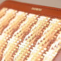 Close-up of a woven mat with a brown border, featuring the brand 'Danilos'.