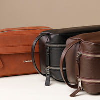 three-toiletry-bag-leather-tan-brown-black-with-silver-hardware-closeup