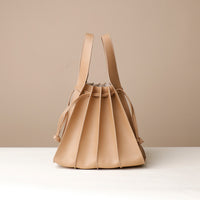 Back view of beige Luxury leather bucket bag with multiple carry options