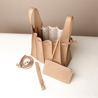 Open interior of beige Luxury leather bucket bag with multiple carry options