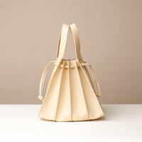 Back view of white Luxury leather bucket bag with multiple carry options