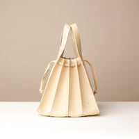 Front view of white Luxury leather bucket bag with multiple carry options