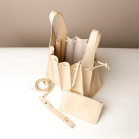 Open interior of white Luxury leather bucket bag with multiple carry options