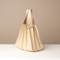 Side view of white Luxury leather bucket bag with multiple carry options