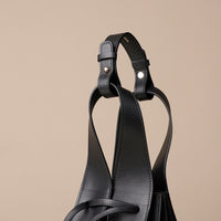 Close up view of black Luxury leather bucket bag with multiple carry options