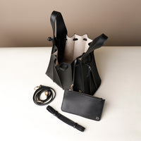 Open interior of black Luxury leather bucket bag with multiple carry options
