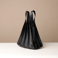 Side view of black Luxury leather bucket bag with multiple carry options