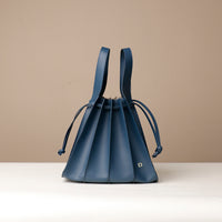 Front view of blue Luxury leather bucket bag with multiple carry options
