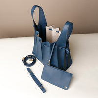 Open interior of blue Luxury leather bucket bag with multiple carry options