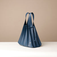 Side view of blue Luxury leather bucket bag with multiple carry options