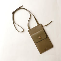 Green crossbody bag on a white background