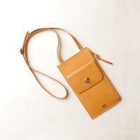Yellow crossbody bag on a white background