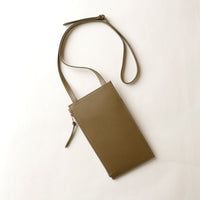 Green crossbody bag on a white background