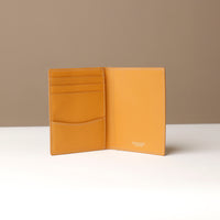 Yellow leather wallet open against a neutral background