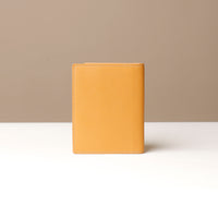Yellow leather wallet on a neutral background