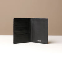 Black leather wallet open on a neutral background