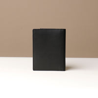 Black leather wallet on a neutral background