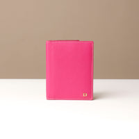 Pink leather wallet with a beige background