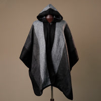 Hooded cape with black and gray gradient on a mannequin against a brown background