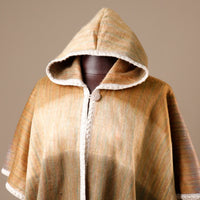 Hooded coat with plaid pattern on a mannequin against a beige background