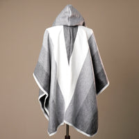 Gray and white hooded towel on a mannequin against a brown background