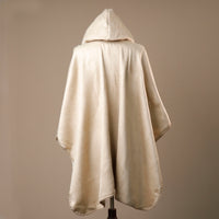 Beige hooded cloak on a mannequin against a beige background