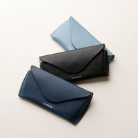 Three glasses cases in black, blue, and light blue on a white background.