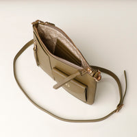 Beige handbag with a strap on a light beige background