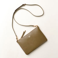Green crossbody bag on a white background