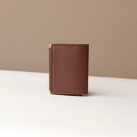 Brown leather wallet on a neutral background