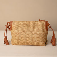 Sassy Satchel 26 Raffia Pana handcrafted with raffia and premium leather, with a pana leather strap, in a beige background, back view
