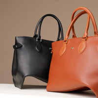 Front view of Saule black and cognac brown leather tote – luxury handcrafted bag with minimal hardware and double handle